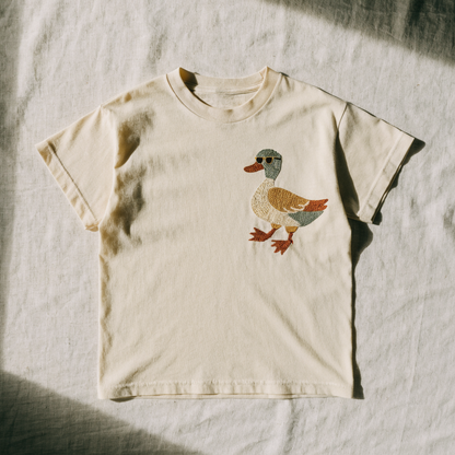 Cream cotton t-shirt with a duck in sunglasses embroidered on the left chest